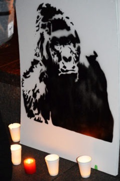 A poster of Harambe, mimicking the setup of an actual funeral.