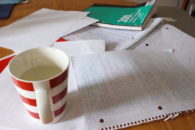 Photo of schoolwork and coffee