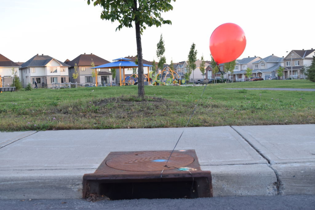 Photo of balloon attached to sewer grate