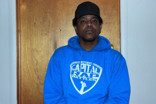Dully Neff wearing his Capital Rap Battles hoodie to represent the community.